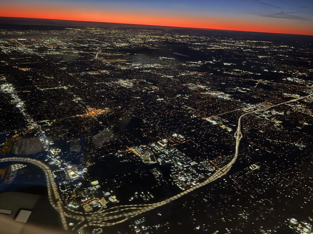 aerial shot of city lights as sun rises